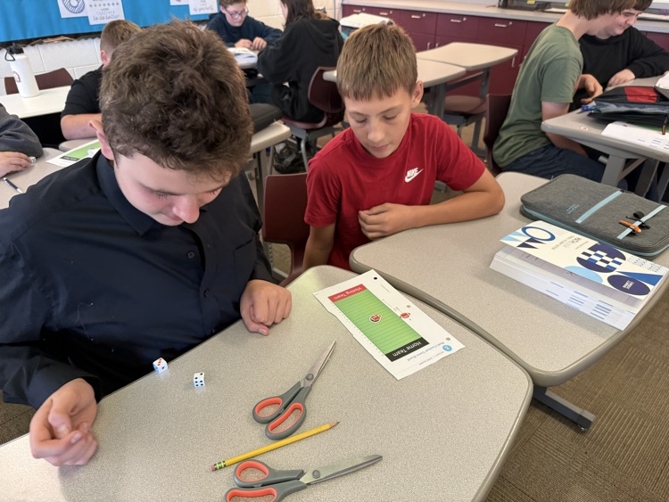 two students rolling dice and playing integer football