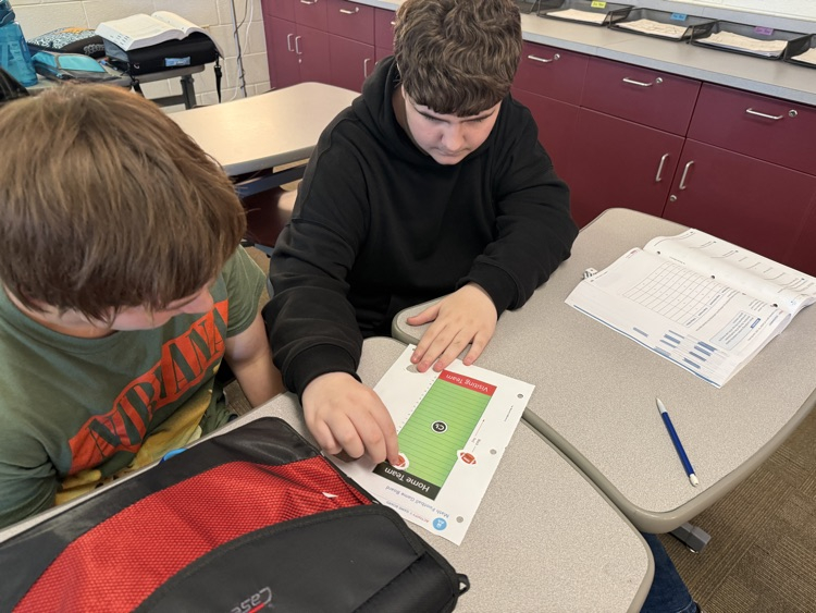 two students rolling dice and playing integer football
