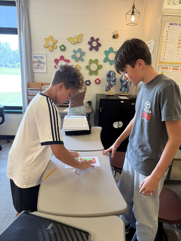 two students rolling dice and playing integer football