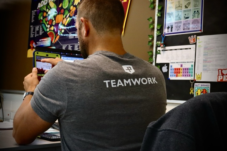 teacher wearing a shirt that says teamwork