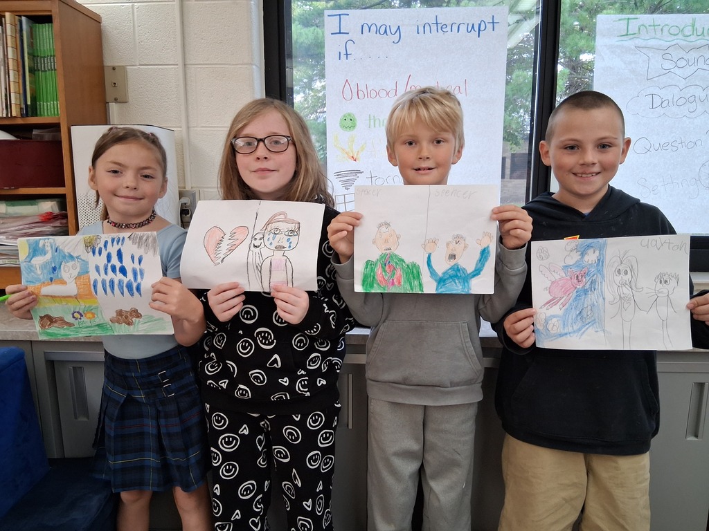 Students posing with idiom illustrations.