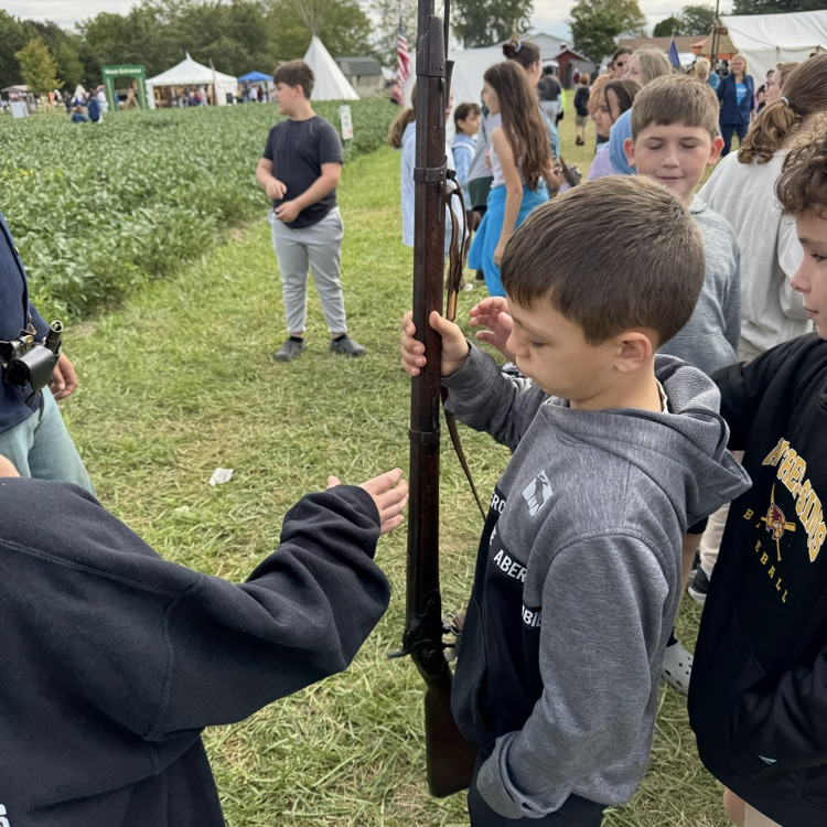 The kids got to hold a real rifle after it was shot.