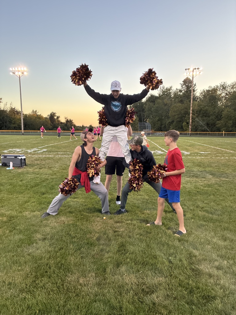 A group of boys in a cheerleading stunt.