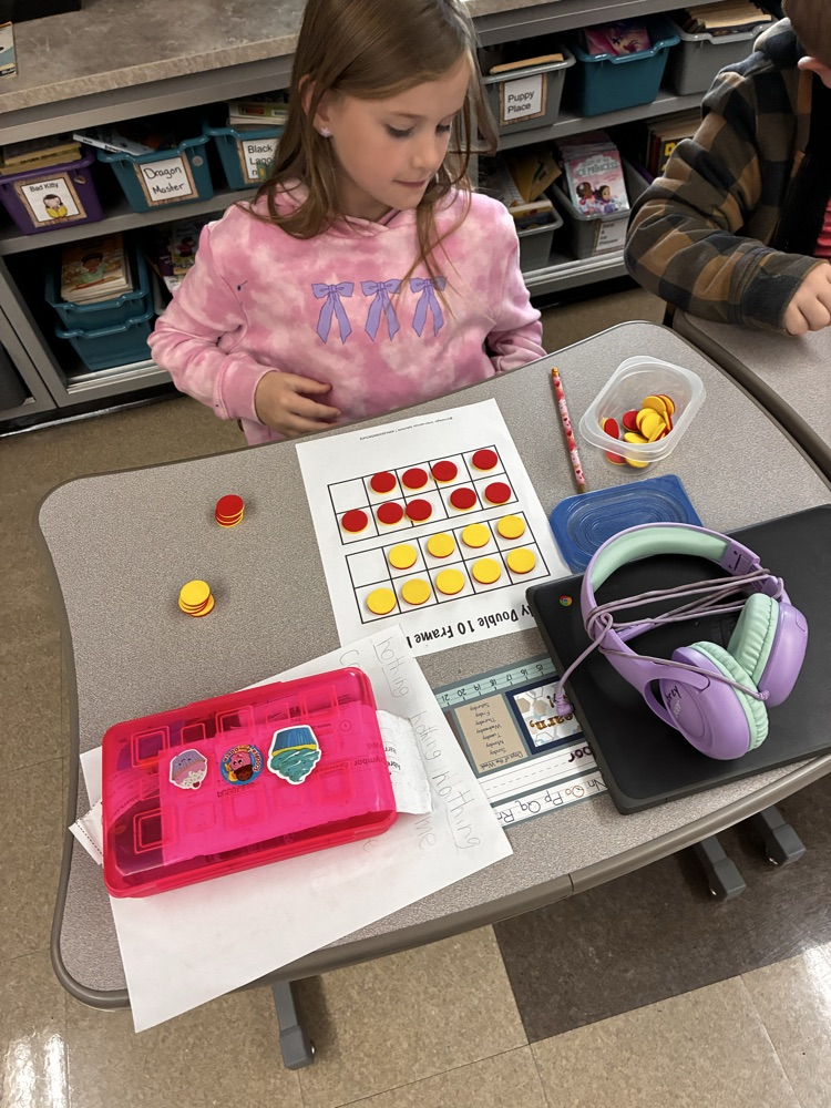 Student work with math double sided math manipulative. 