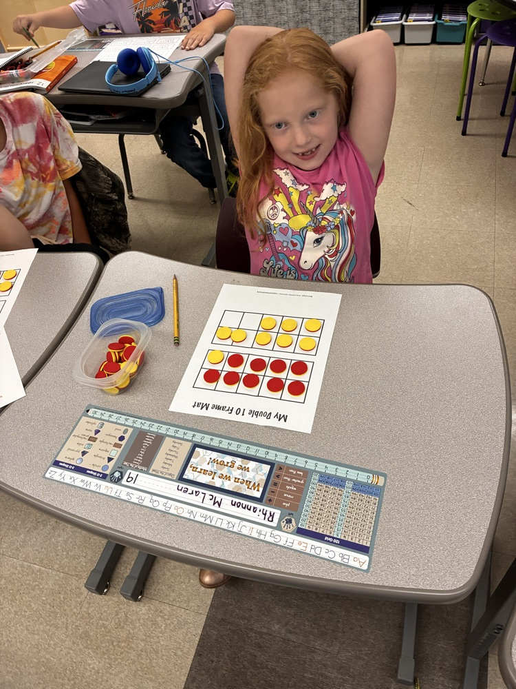 Student work with math double sided math manipulative. 