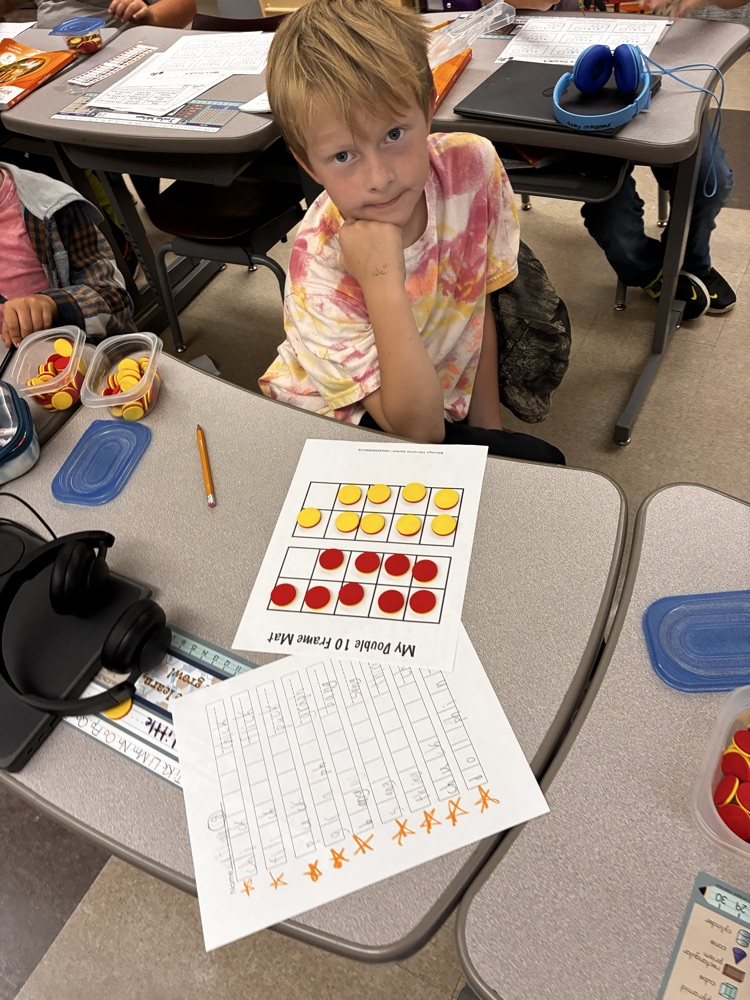 Student work with math double sided math manipulative. 