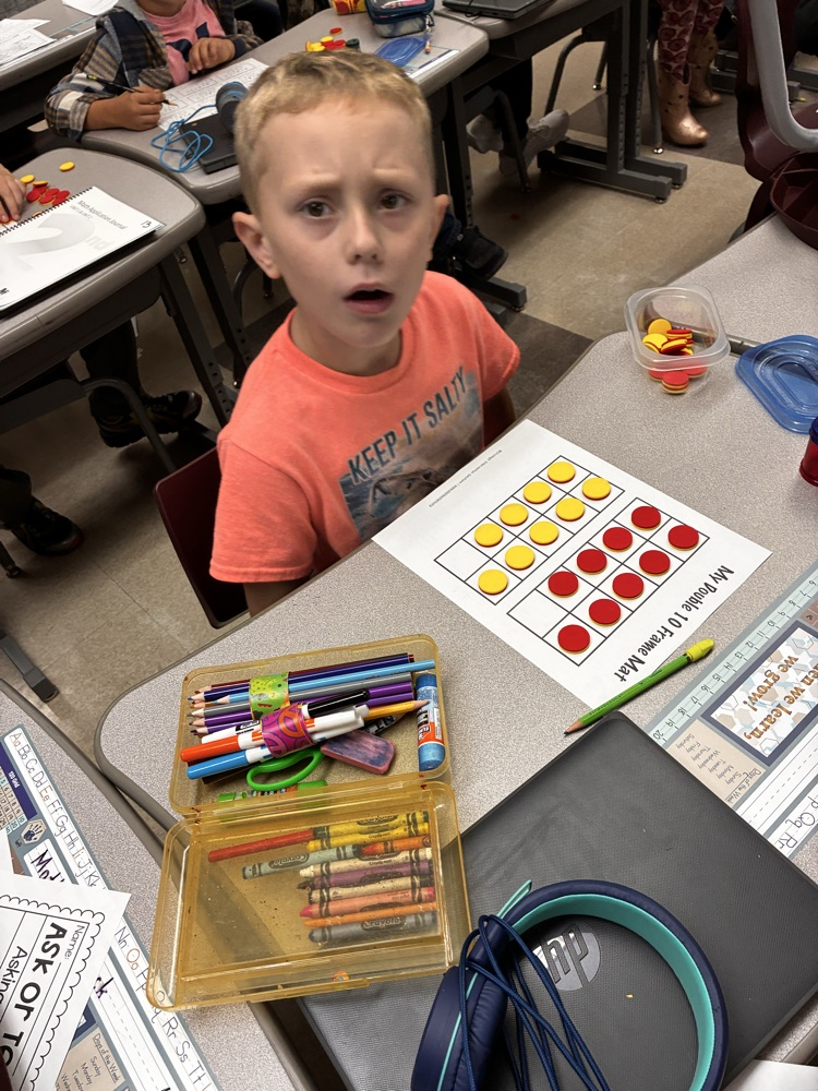 Student work with math double sided math manipulative. 