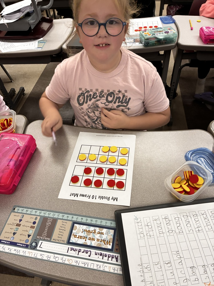 Student work with math double sided math manipulative. 