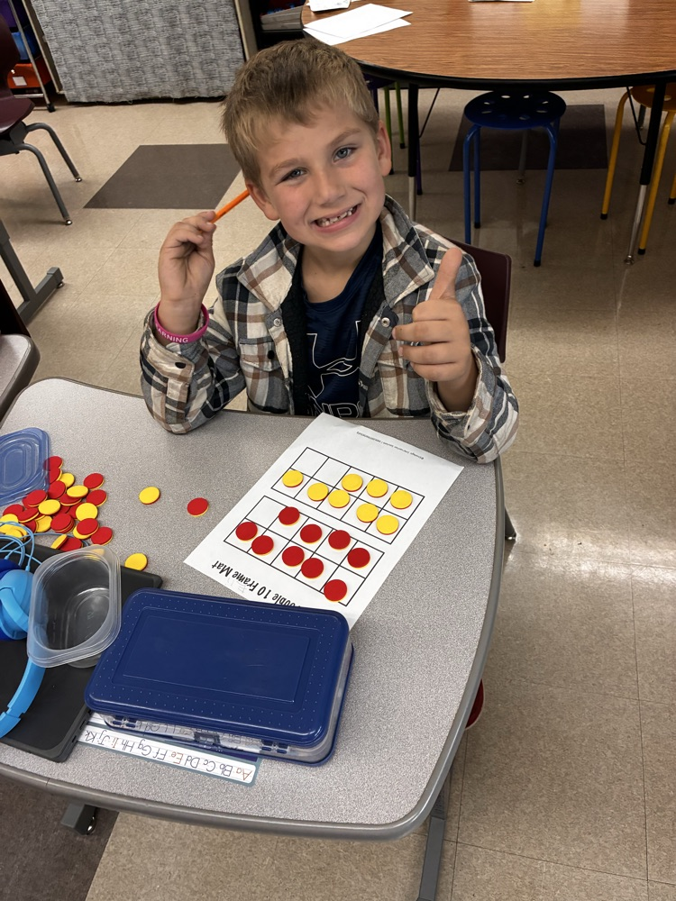 Student work with math double sided math manipulative. 