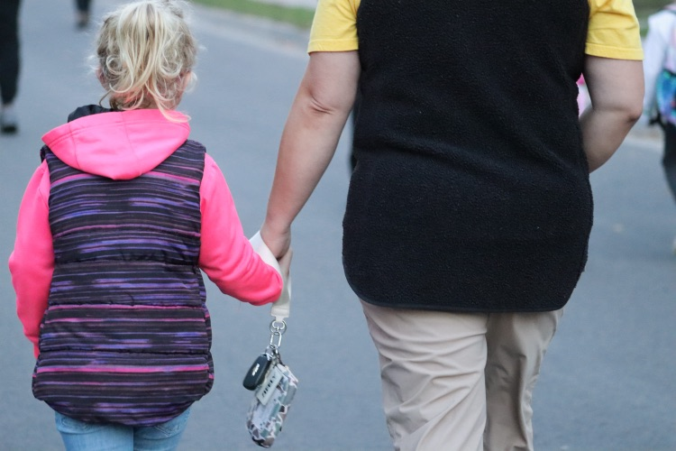 mom holding her kids hand