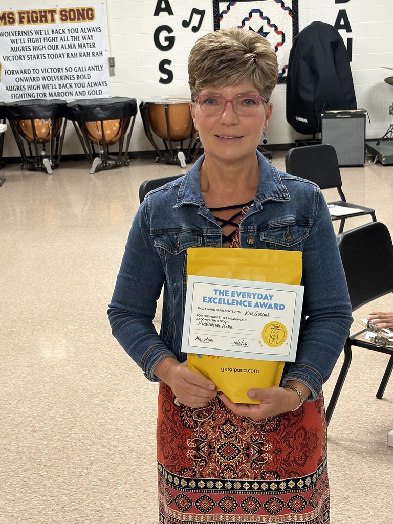 Ms. Gordon holding a yellow gift pack.