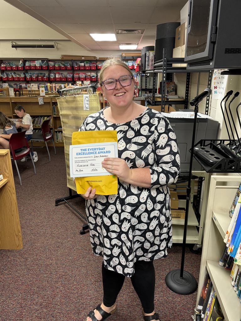 Ms. Anderson holding a yellow gift pack.