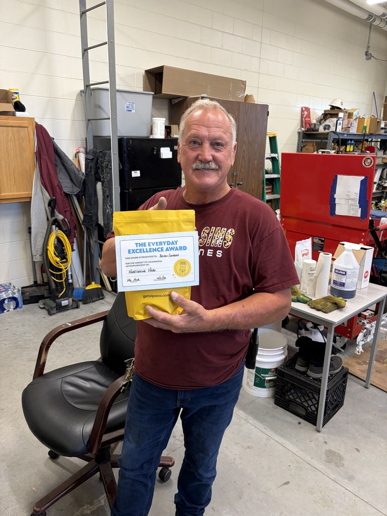 Mr. Duncan holding a yellow gift pack.
