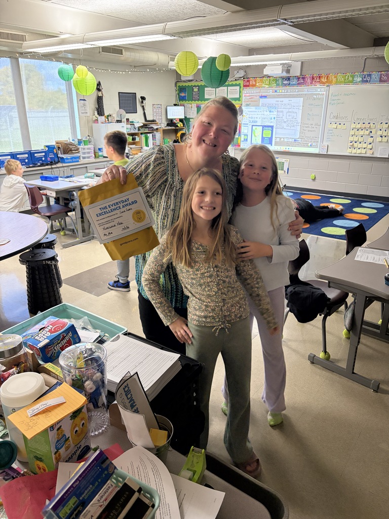 Ms. Swaid holding a yellow gift pack.