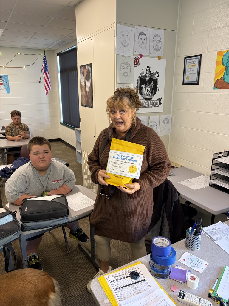 Ms. Richardson holding a yellow gift pack.