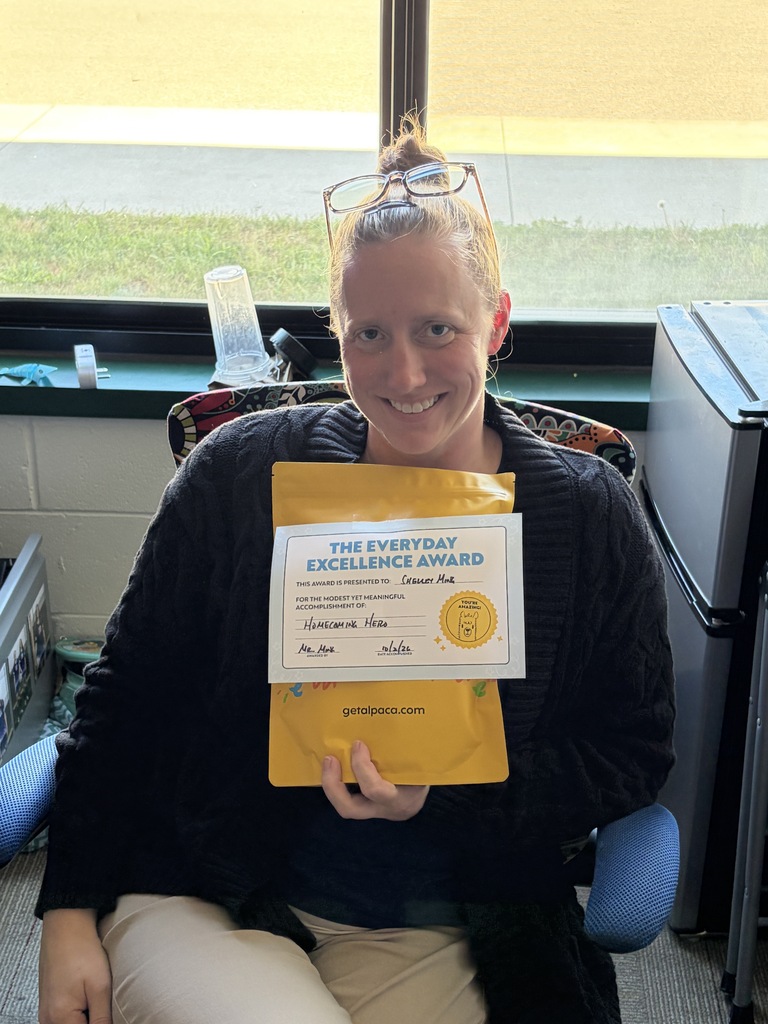 Ms. Ming holding a yellow gift pack.