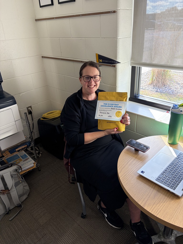 Ms. Steinbauer holding a yellow gift pack.
