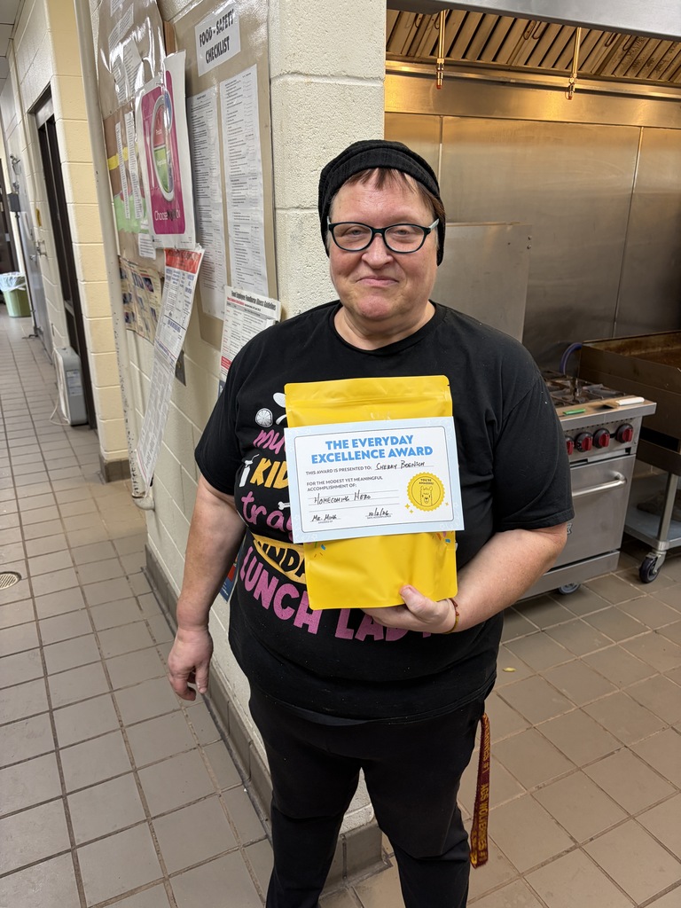 Ms. Boensch holding a yellow gift pack.