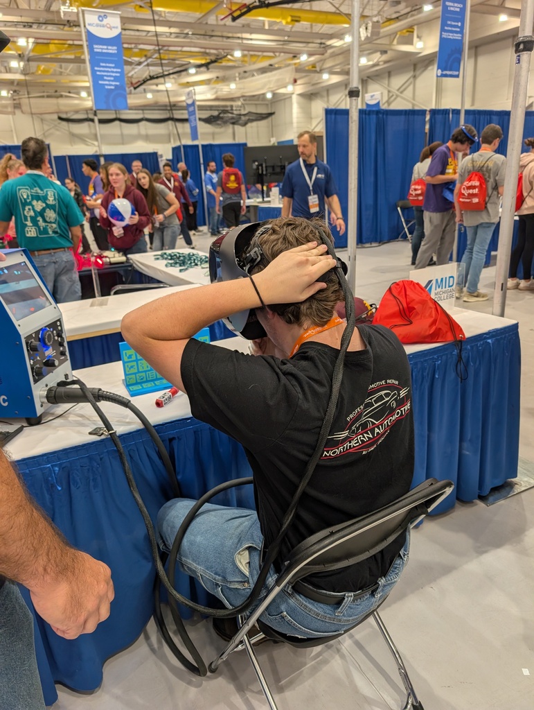 student puts on VR welding headset to do a welding simulator
