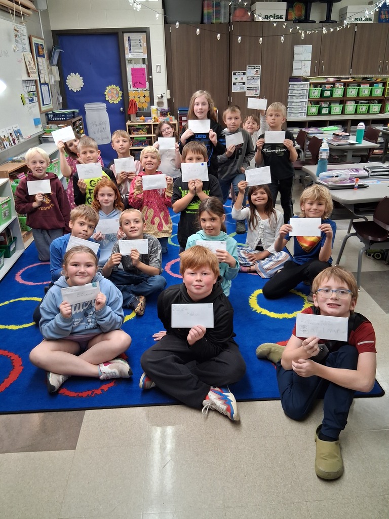 Students holding letters