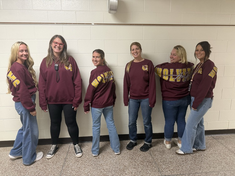 Staff members wearing new Au Gres sweatshirt. 