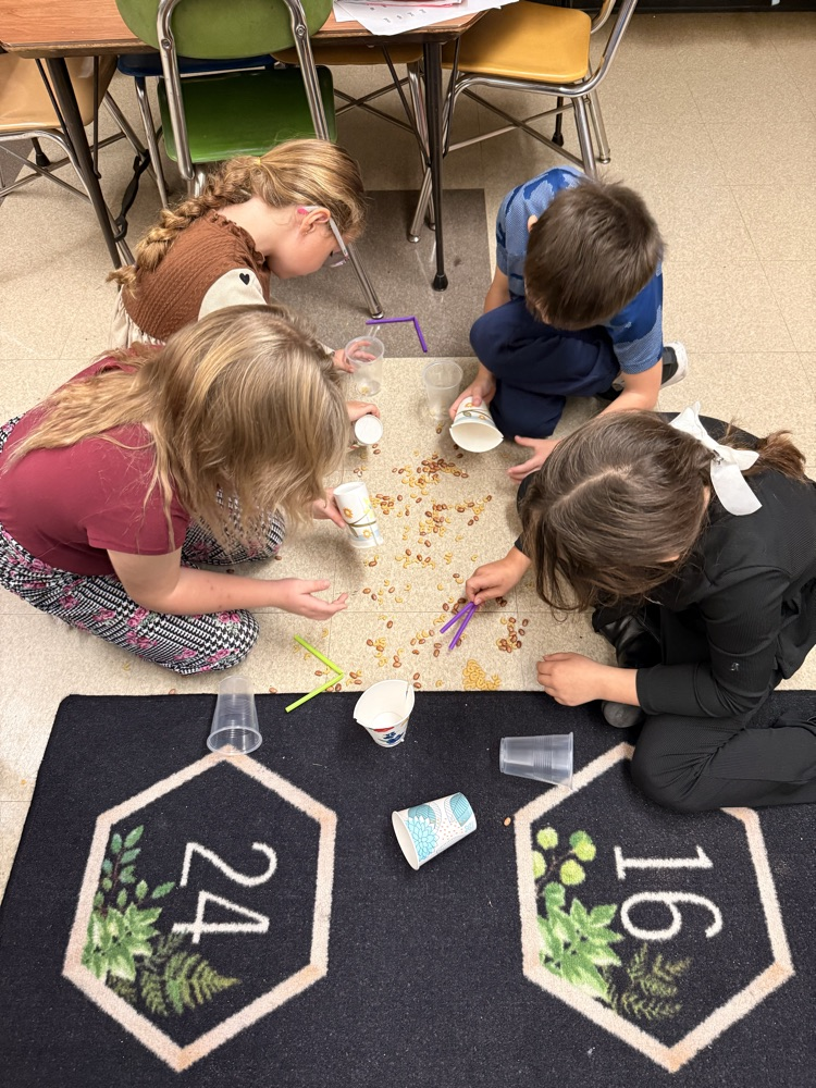 students using different bird beaks to pick up “food"