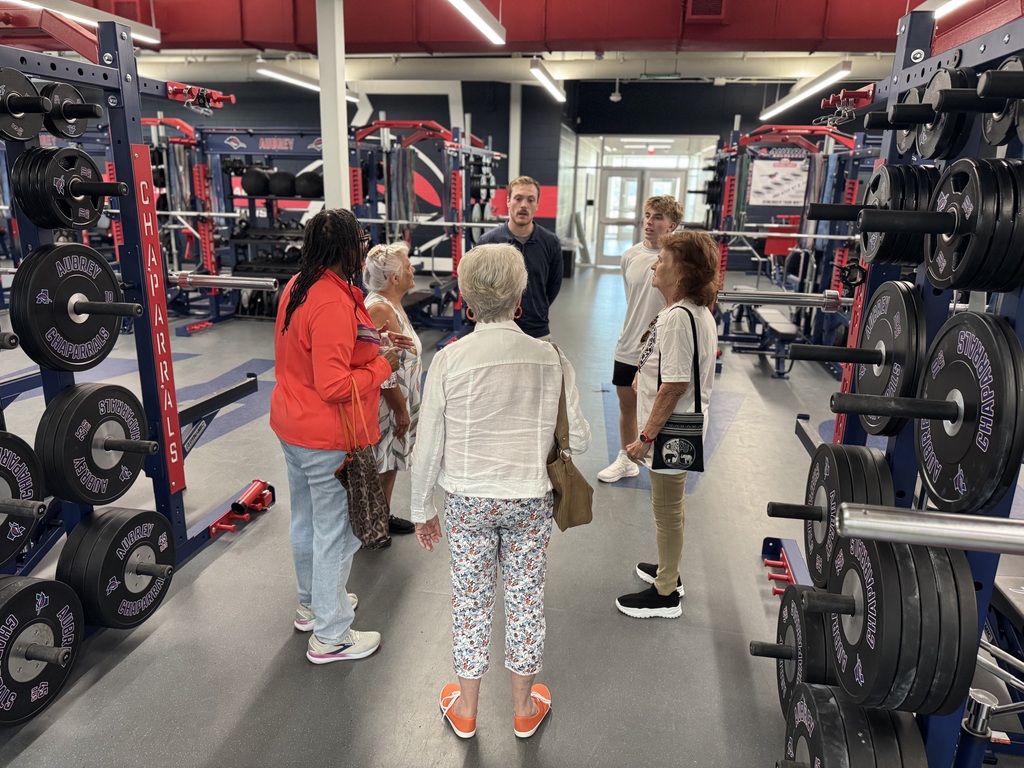 Chaparral Legacy Cooperative members on tour inside weight room of Aubrey High School multipurpose facility
