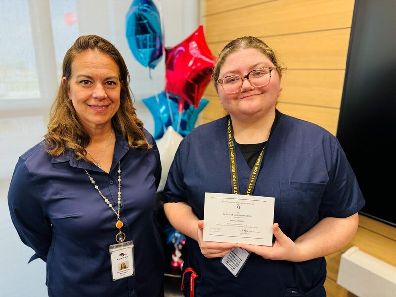 Commended student holding certificate poses with principal Dr. Vanessa Zavar