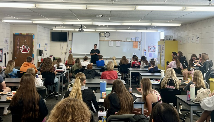 Kaci speaking to members during lunch  