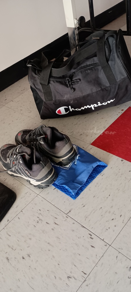 pair of shoes and a duffle bag full of clothing