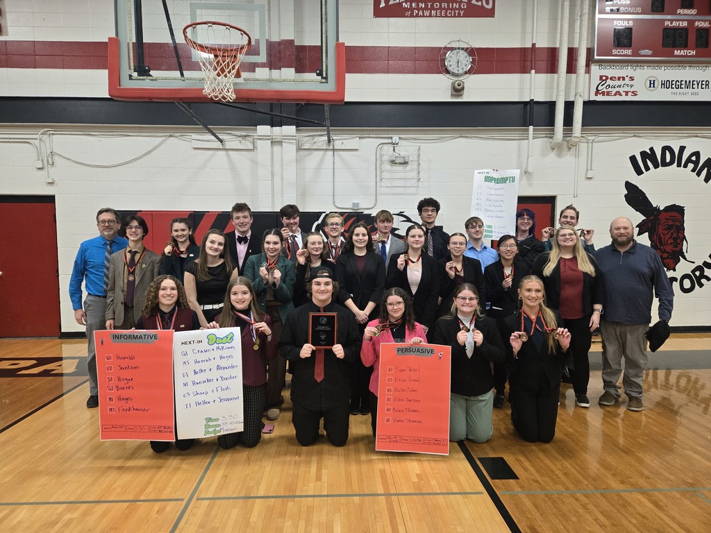The AHS Speech Team holds posters, medals, and the runner up plaque after the Pawnee City tournament.