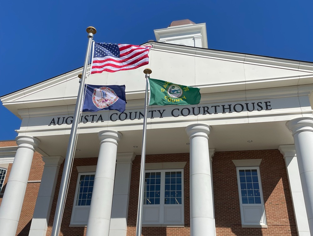 Front of new courthouse building with flags