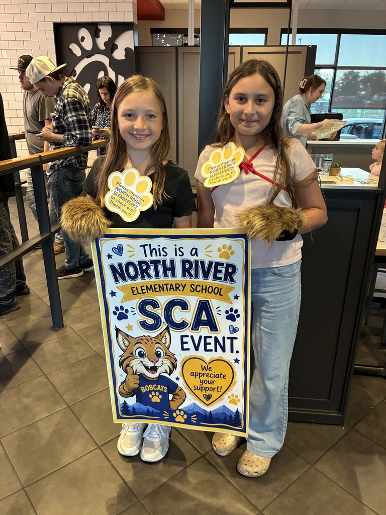 two students holding a North River SCA Event sign at Chick-fil-a