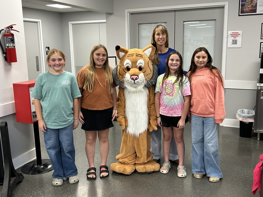 fifth grade students pose with Bobcat at Smiley's ice cream