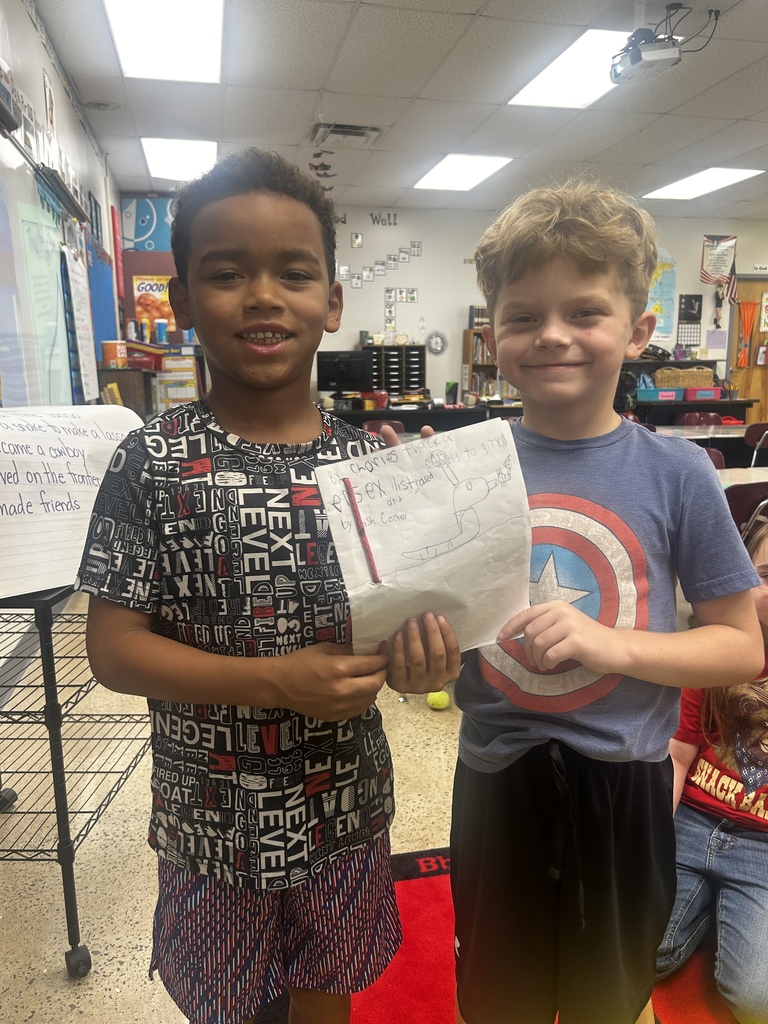 Students holding self made book