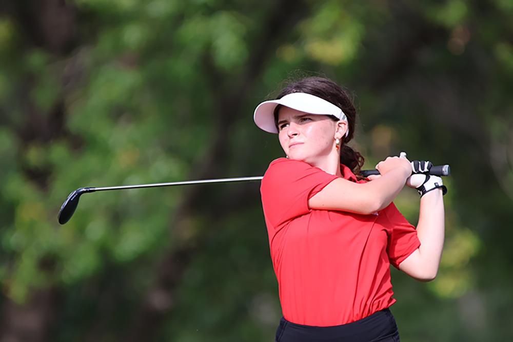 Julia Messere watches her swing through the ball