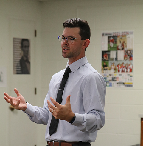 Mr. Patsios teaches in front of the class