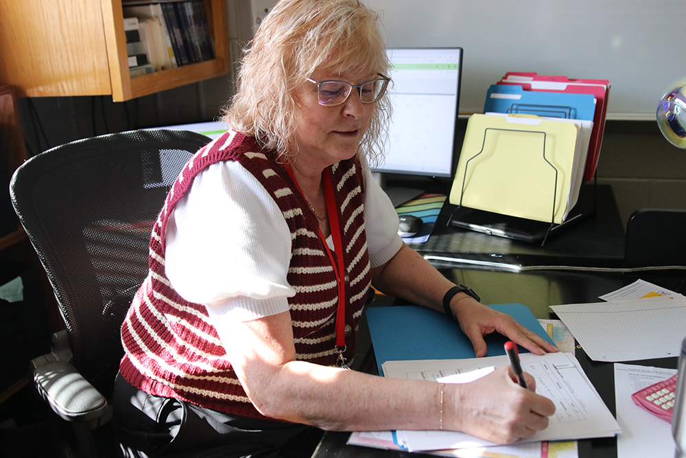 Mrs. Troester grades students' papers