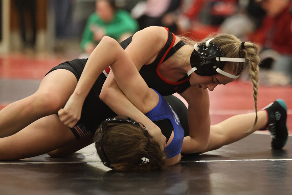 Senior Caly Settles pins her opponent