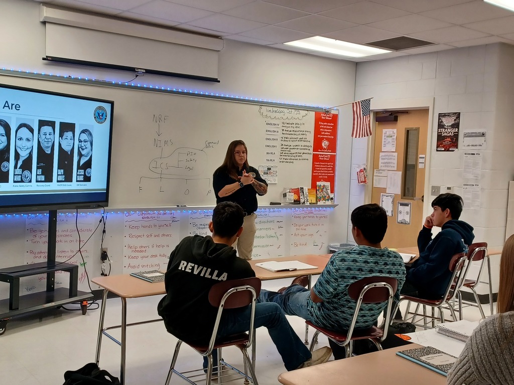 Victoria Disaster Response Team member speaks to a group of students.