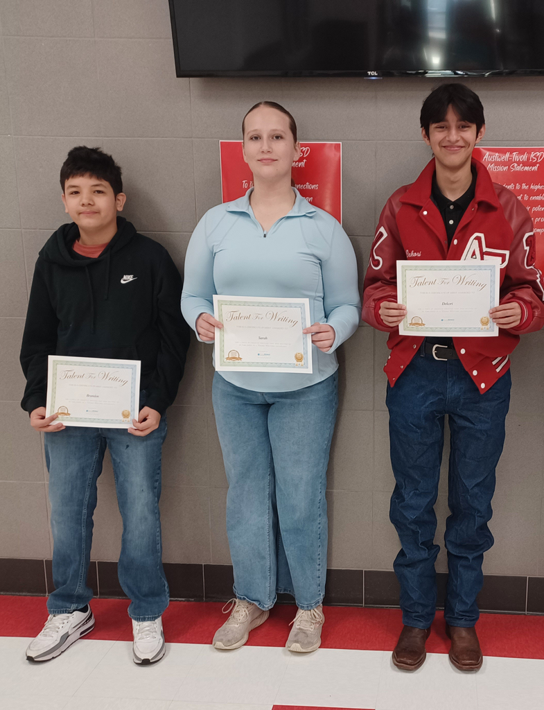 Three students hold certificates.