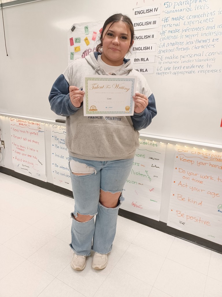 A student holds a certificate.