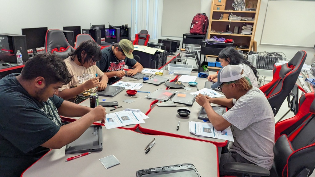Students repairing Chromebooks