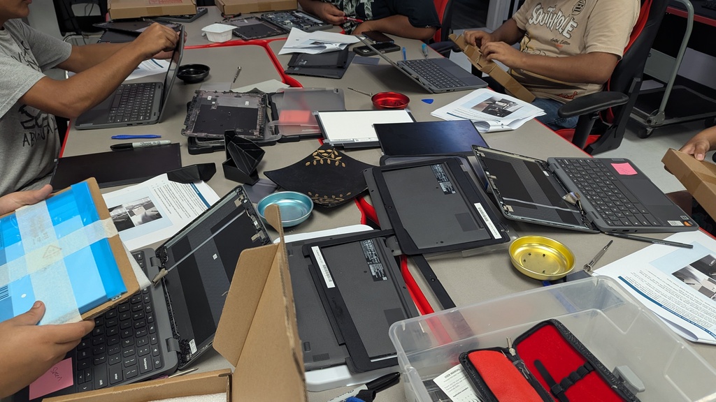 Students repairing Chromebooks