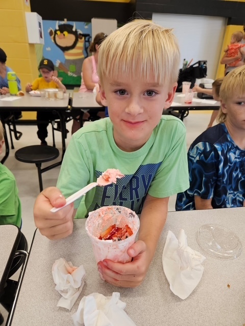 One boy eating dessert. 