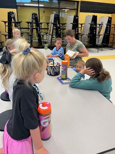 Teacher reading a book to students