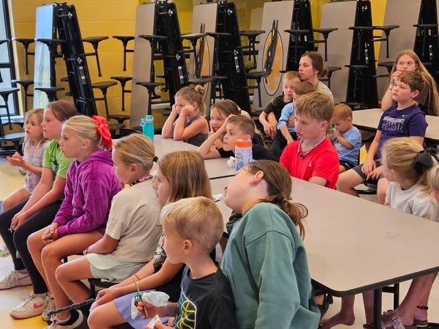 students seated watching presentation