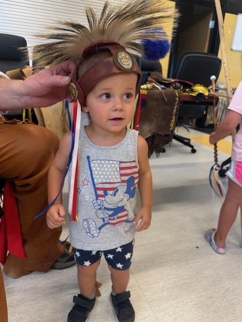 Small child  wearing Mic-O-Say attire