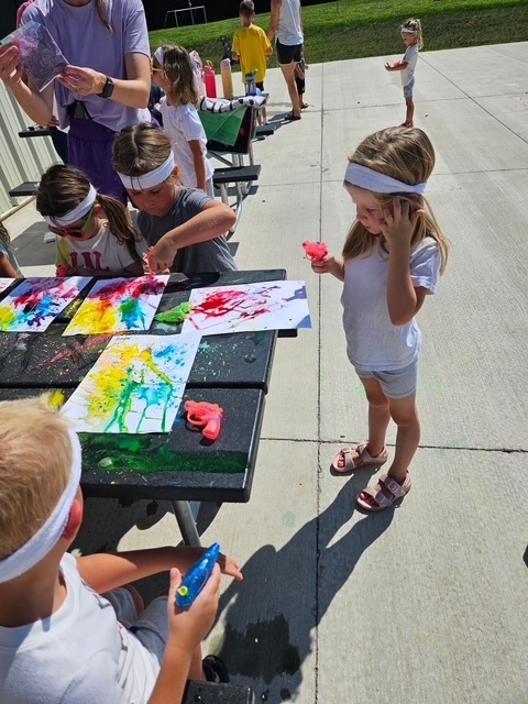 Students making art with water toy
