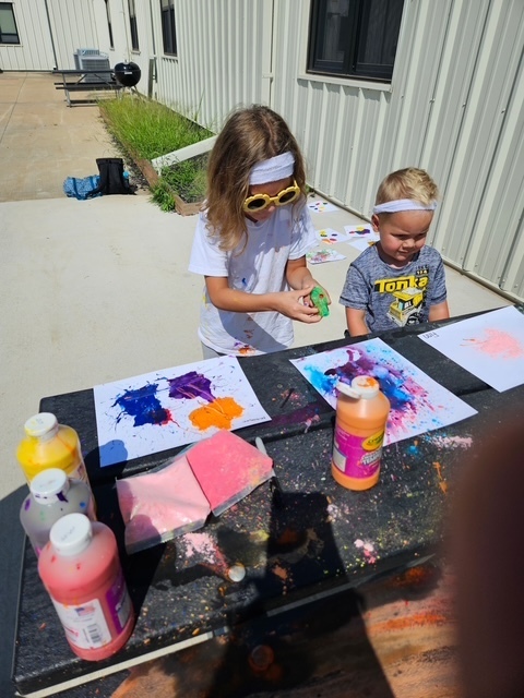 Two young studetns painting